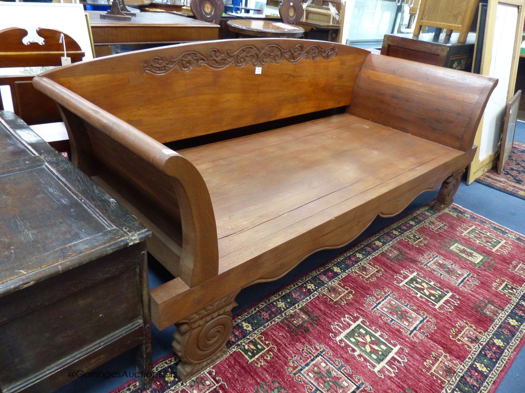 An Indian carved teak day bed, length 220cm, width 87cm, height 89cm